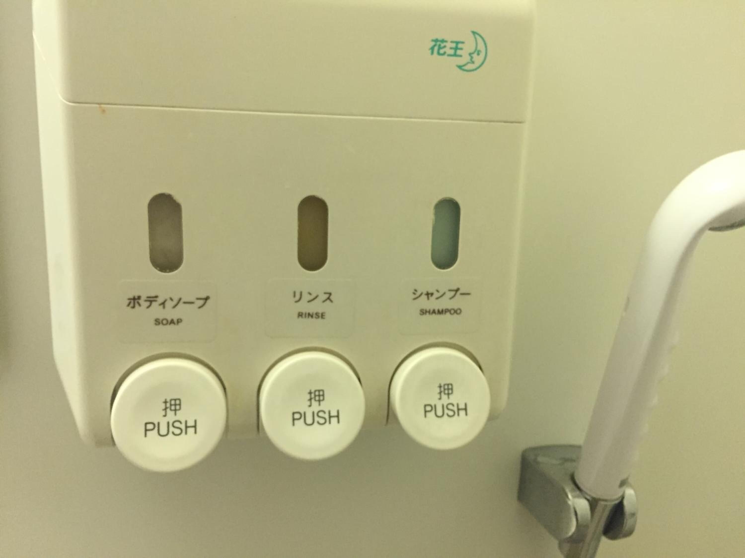 A control panel with three buttons labeled "SOAP," "RINSE," and "SHAMPOO," each with a corresponding push button below.