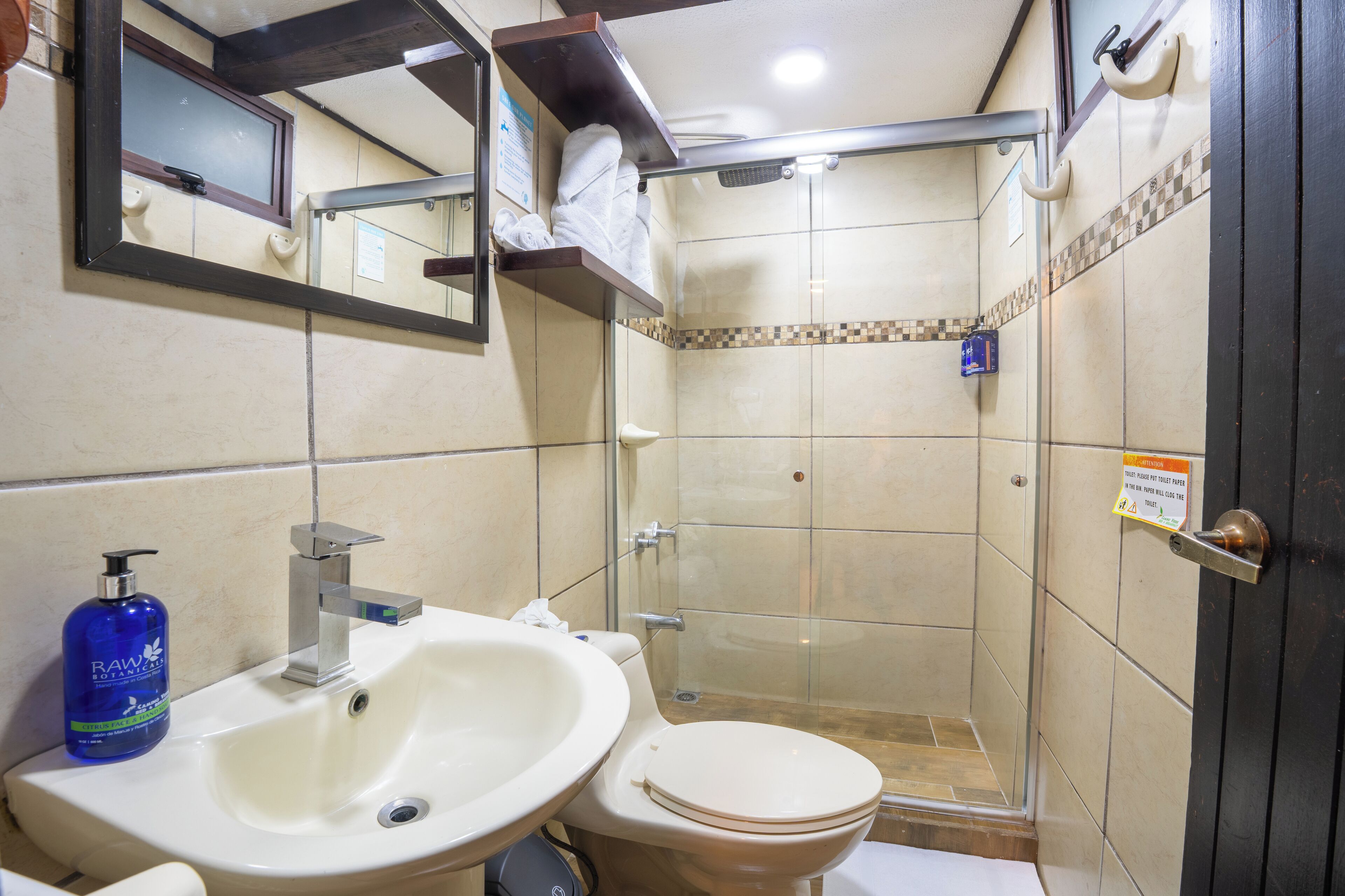 A bathroom with a sink, toilet, and shower.