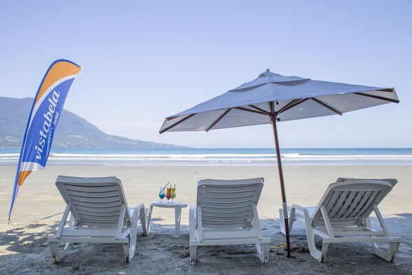 On the beach, sun-loungers, beach umbrellas, beach towels