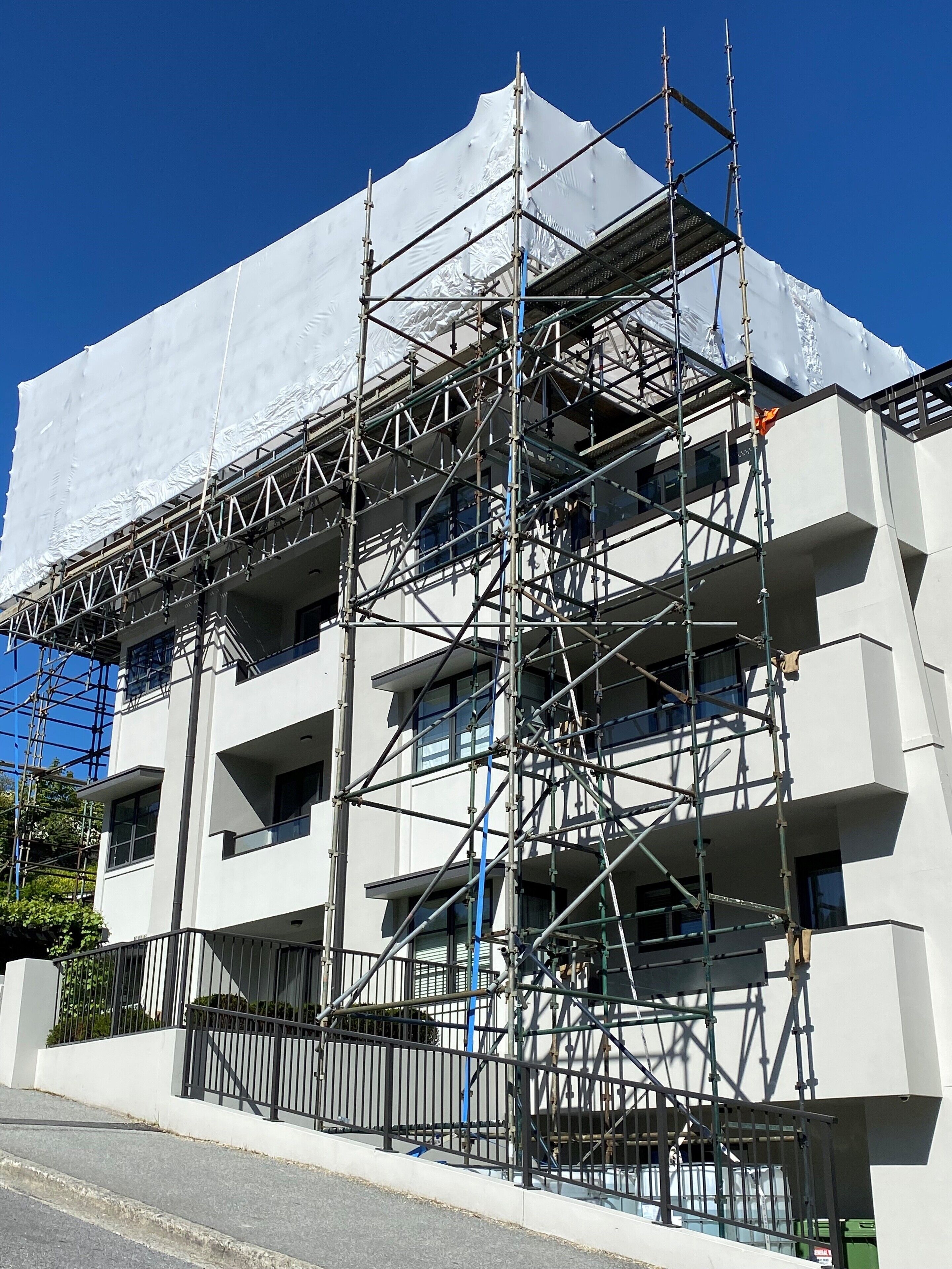 A multi-story building under construction with scaffolding.