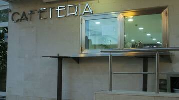 A building with a sign that reads "CAFETERIA" above a window.