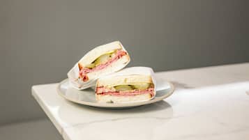 A sandwich cut in half on a white plate.