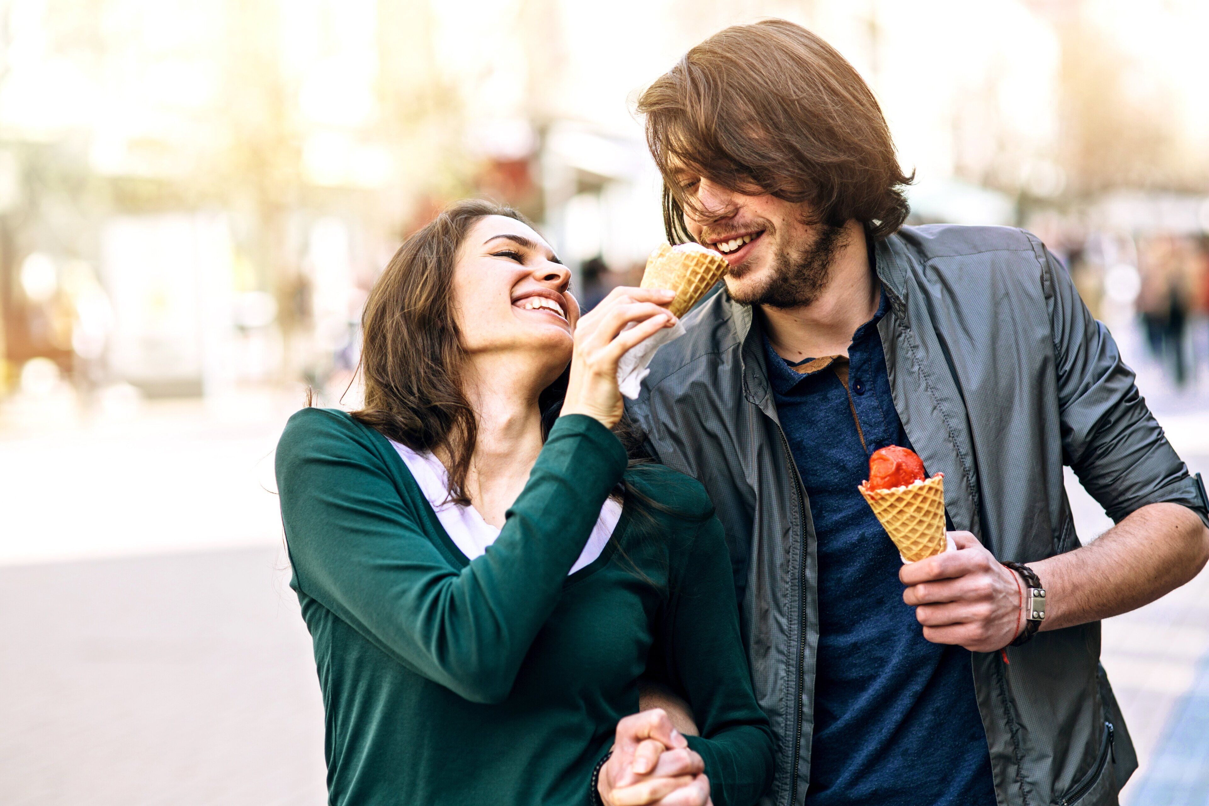 A couple holding an ice cream cone.