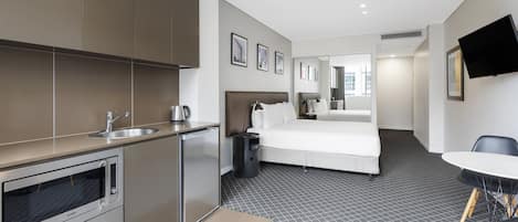 Premium Studio Suite, 1 King Bed | In-room safe, desk, laptop workspace, blackout drapes