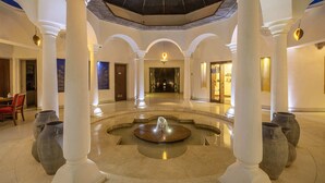 A spacious lobby with a central fountain, white columns, and a high ceiling with a skylight. - The Tree of Life Resort & Spa, Jaipur (Amer)