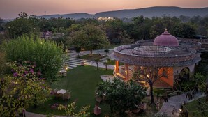 A garden with a gazebo, pathways, and a view of distant hills. - The Tree of Life Resort & Spa, Jaipur (Amer)