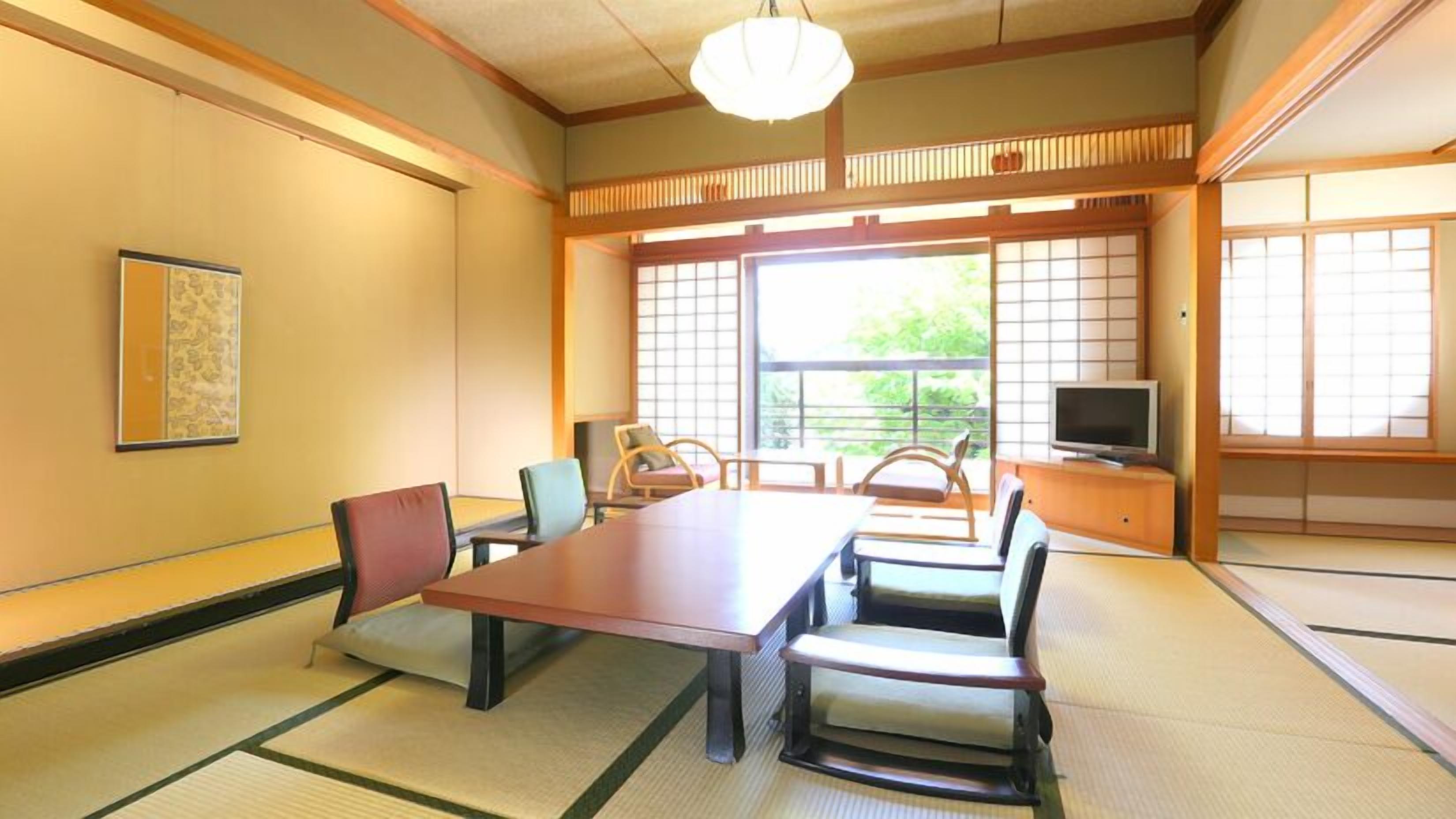 A traditional Japanese room with tatami flooring, a low table, and shoji screens.