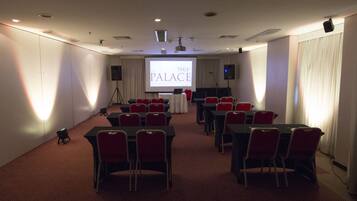 A conference room with tables and chairs arranged for a meeting.