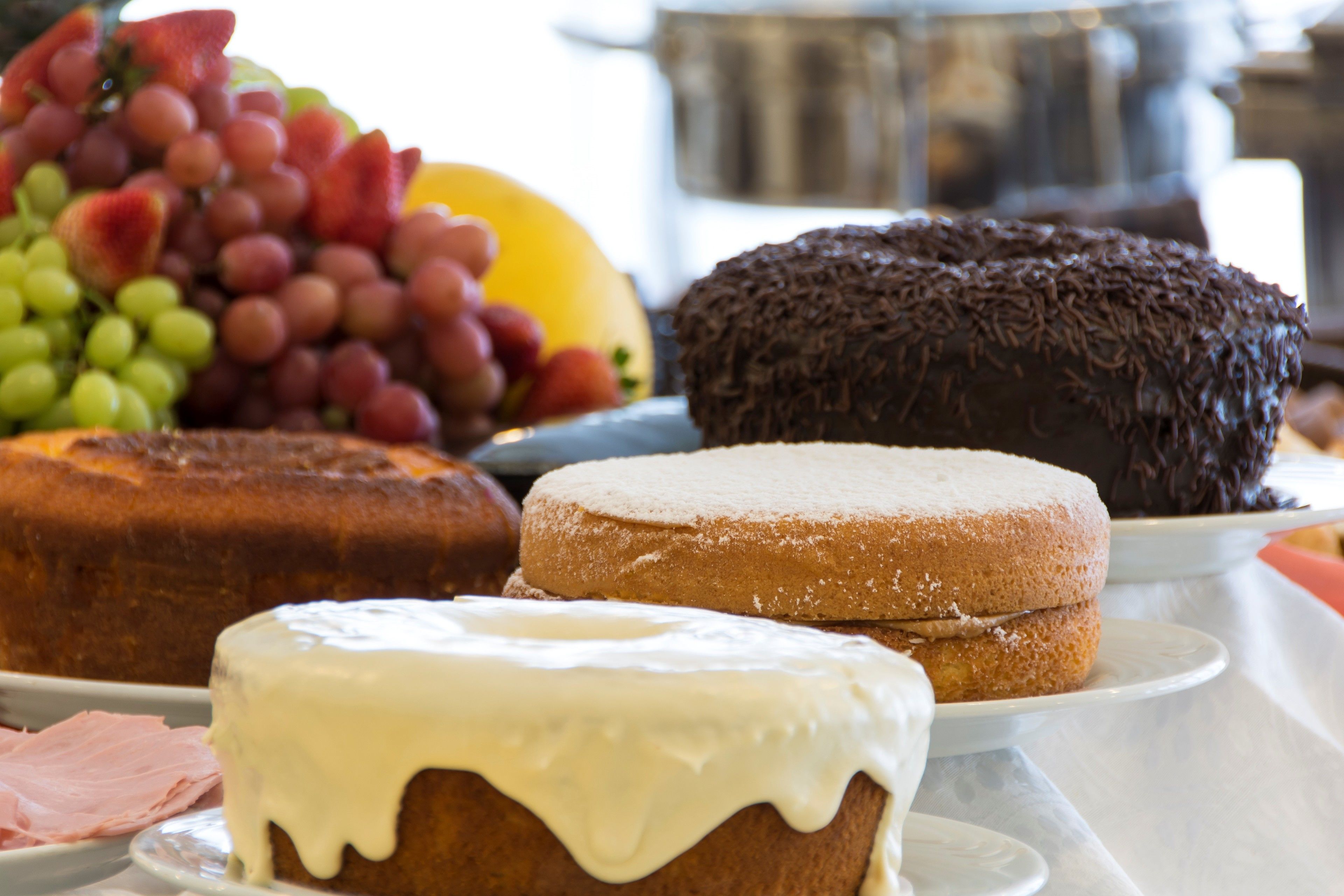 A variety of cakes and pastries on a table.