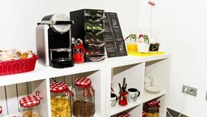 A kitchen area with a coffee maker, jars of spices, and a basket of bread. - Alda Soria Rooms (Soria)