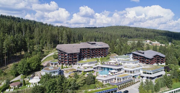A resort with multiple buildings, a swimming pool, and a forested backdrop. - Vier Jahreszeiten am Schluchsee (Schluchsee)