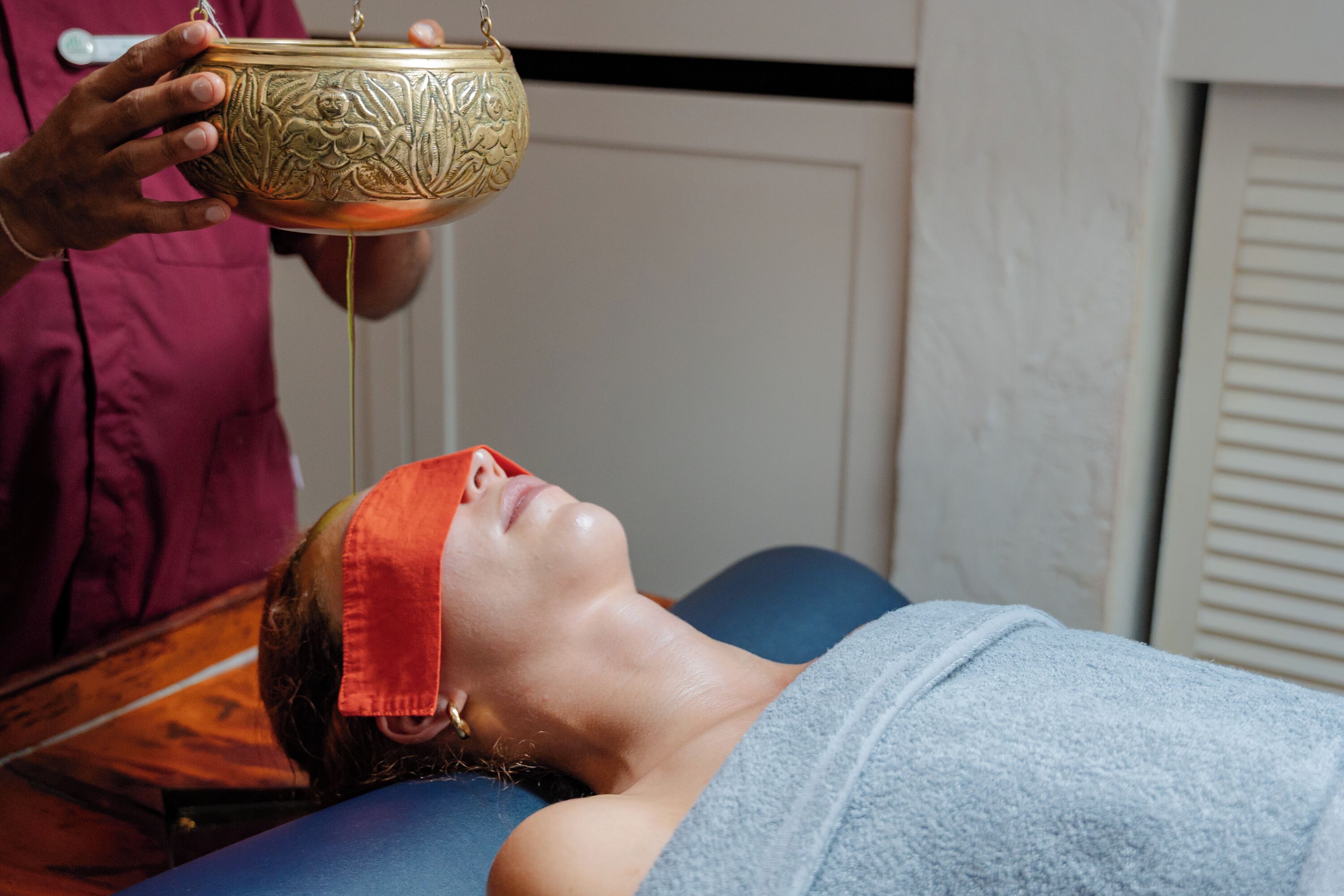 A person lying on a massage table receiving a treatment.