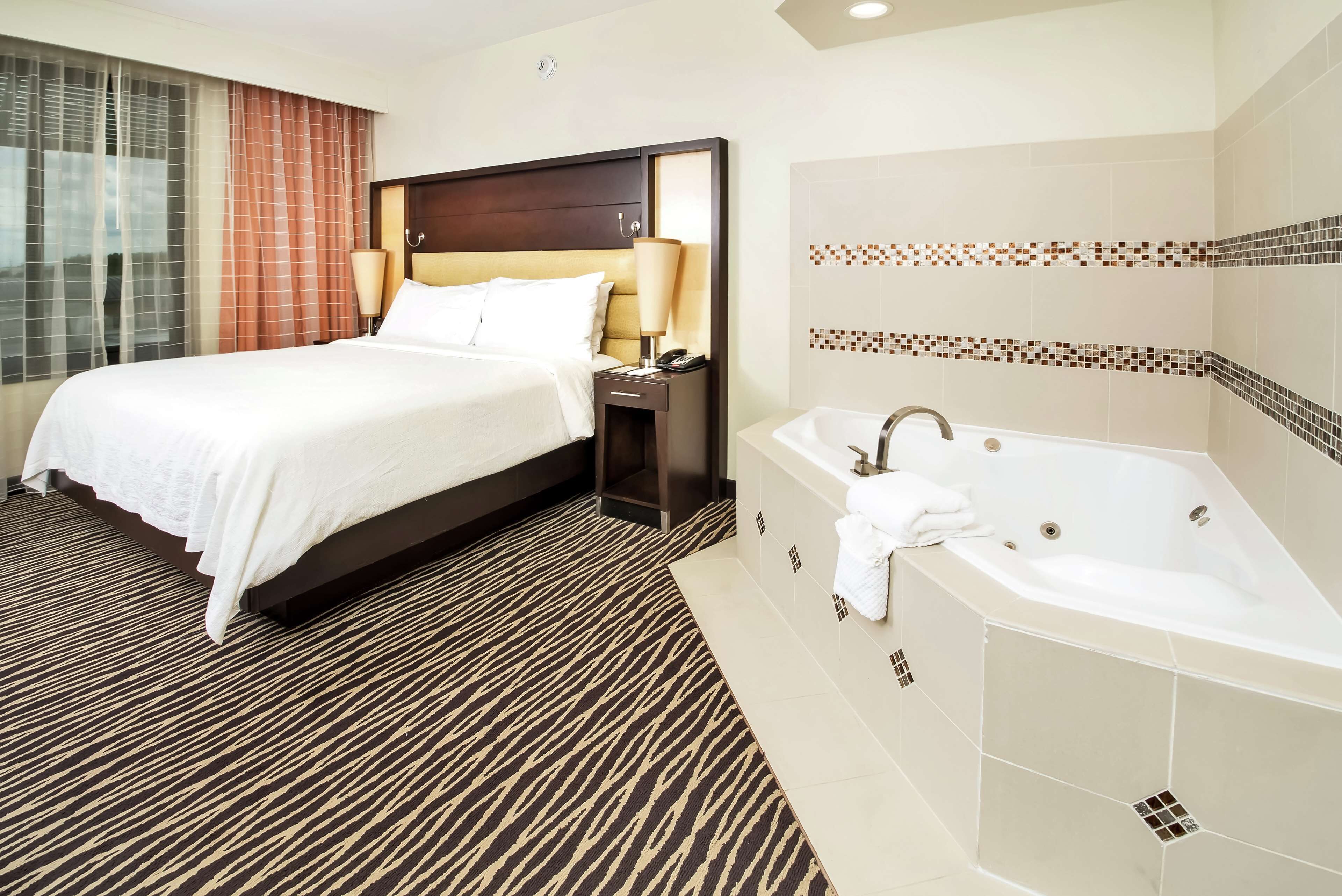 suite, 1 king bed, jetted tub | bathroom | free toiletries, hair dryer, towels