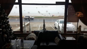 A cozy room with a view of a snowy landscape and a Christmas tree. - The Fame (Blackpool)