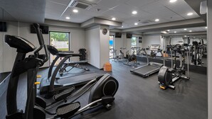 A gym with treadmills, elliptical machines, and weight equipment.