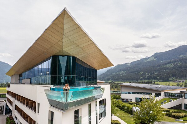 A modern building with a distinctive triangular roof and large glass windows. - TAUERN SPA Zell am See - Kaprun (Kaprun)