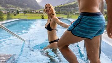 A swimming pool with a view of mountains in the background.