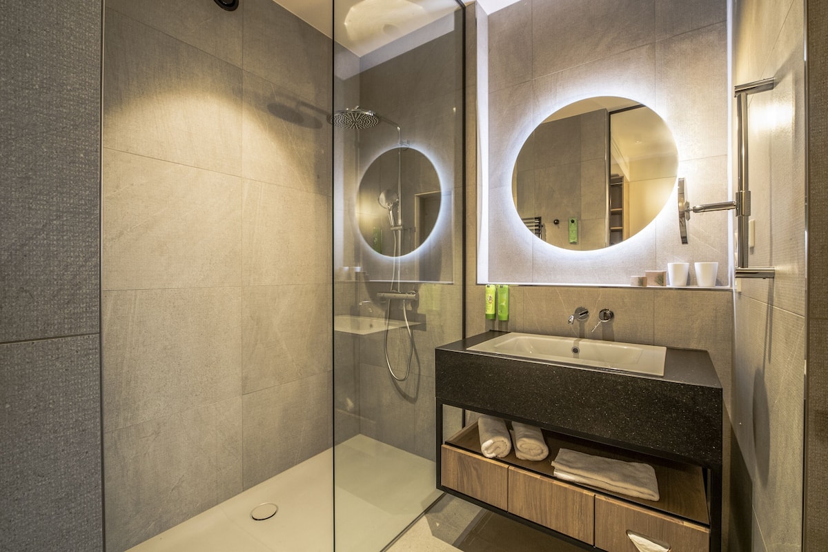 shower, hair dryer, bathrobes, slippers