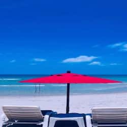 On the beach, white sand, sun-loungers, beach umbrellas