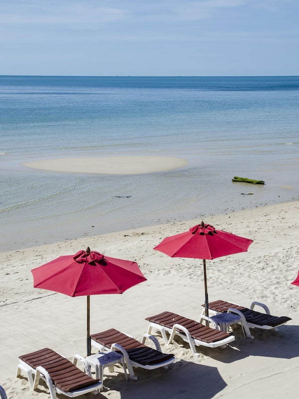 On the beach, white sand, sun-loungers, beach umbrellas