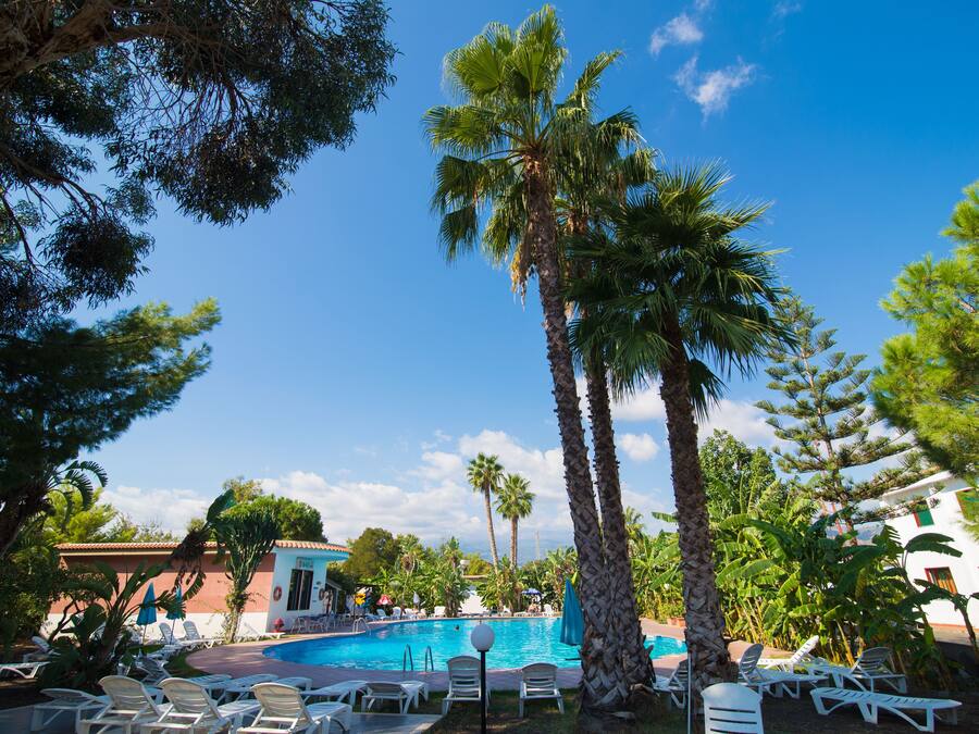 Outdoor pool, open 9:00 AM to 8 PM, pool umbrellas