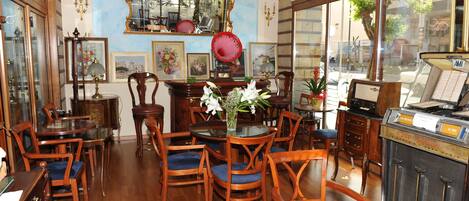 A vintage-style room with wooden furniture, a glass table, and a vintage radio.