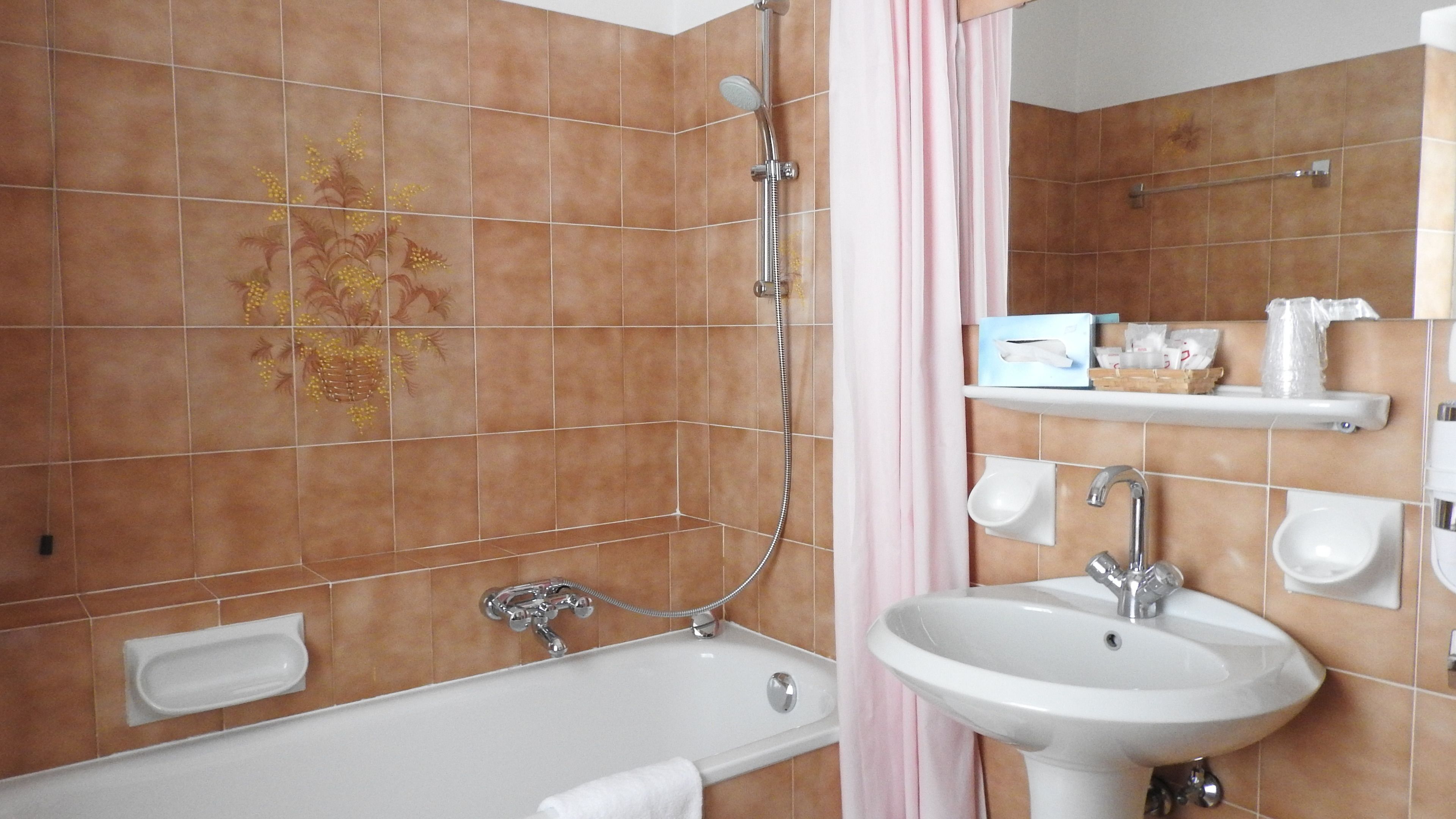 A bathroom with a bathtub, a sink, and a shower.