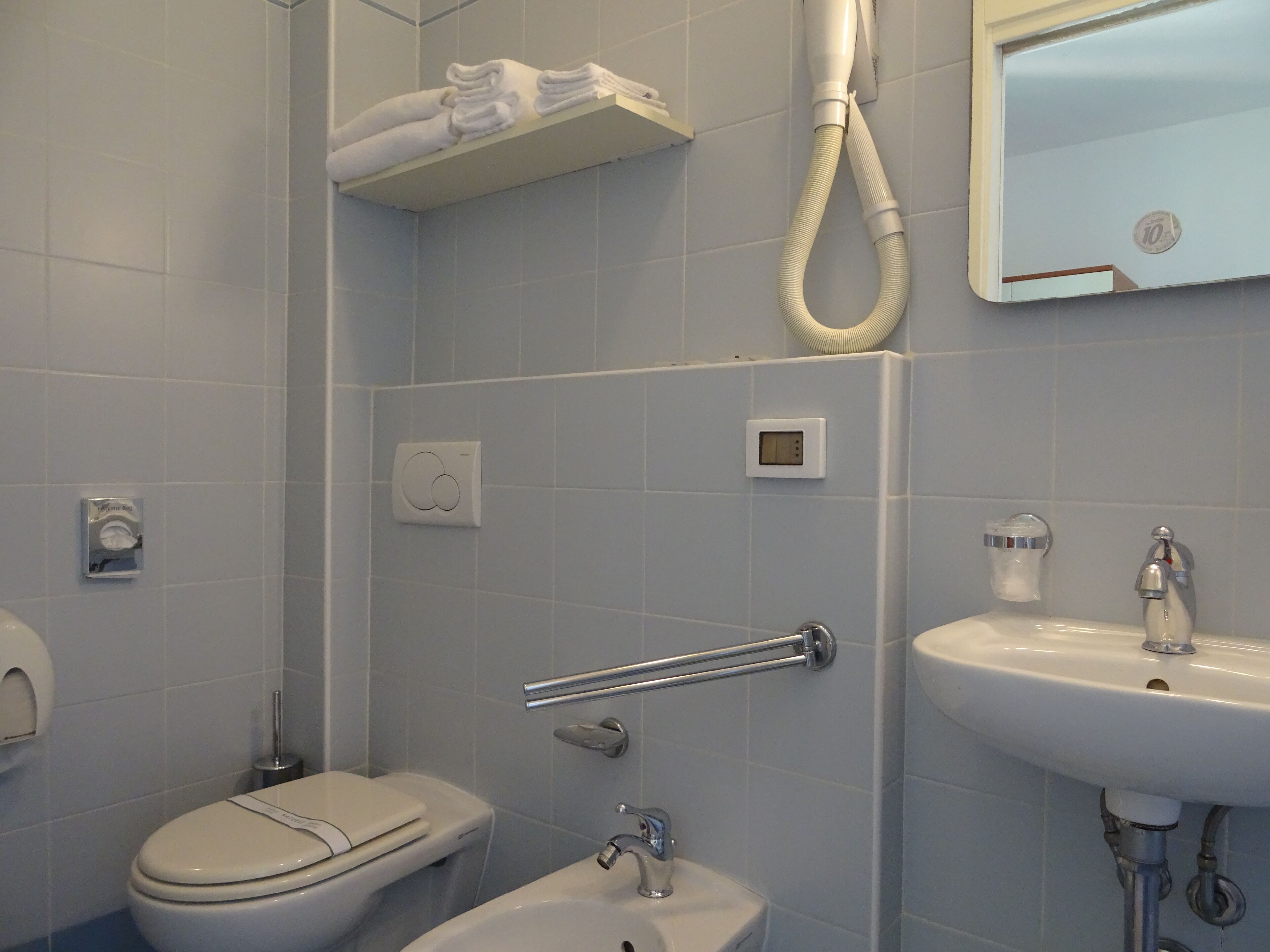 shower, hair dryer, bidet, towels