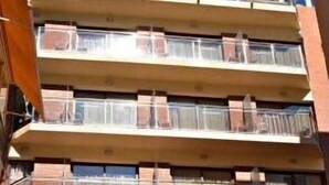 A multi-story hotel with a red awning and a sign that reads "Hotel." - Primavera (Benidorm)