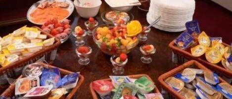 A buffet table with various food items and condiments.