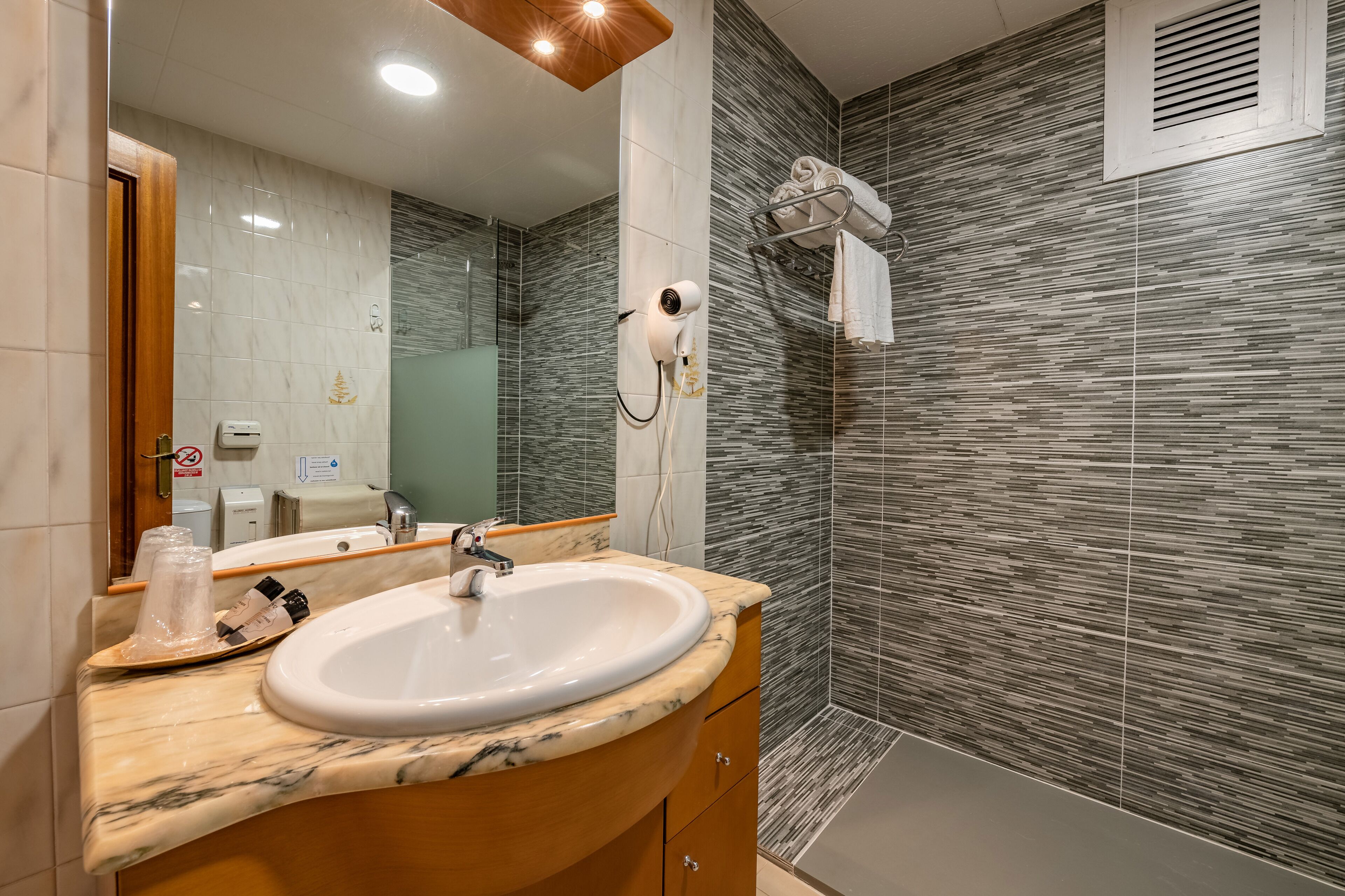 rainfall showerhead, hair dryer, towels, soap