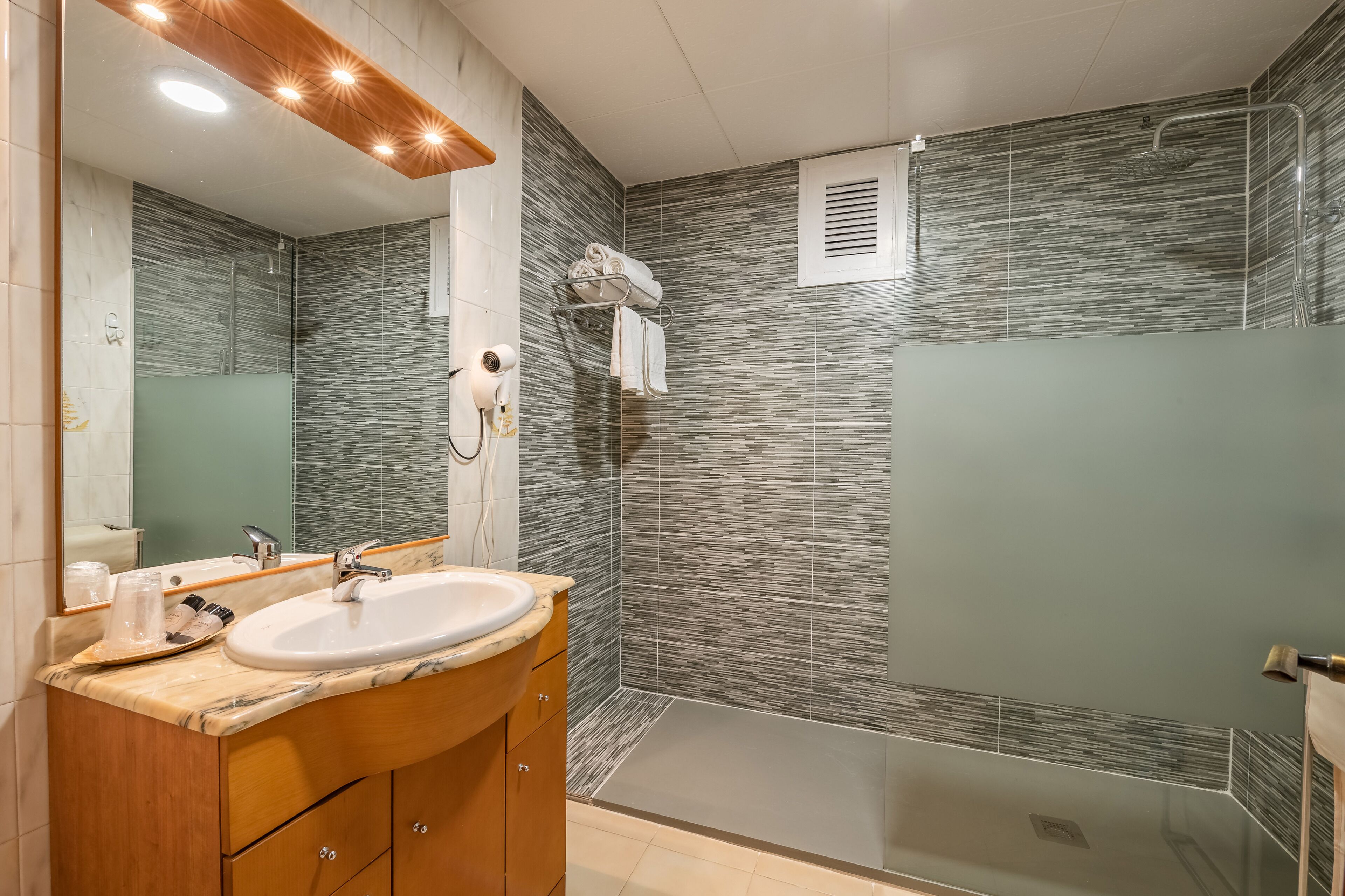 rainfall showerhead, hair dryer, towels, soap