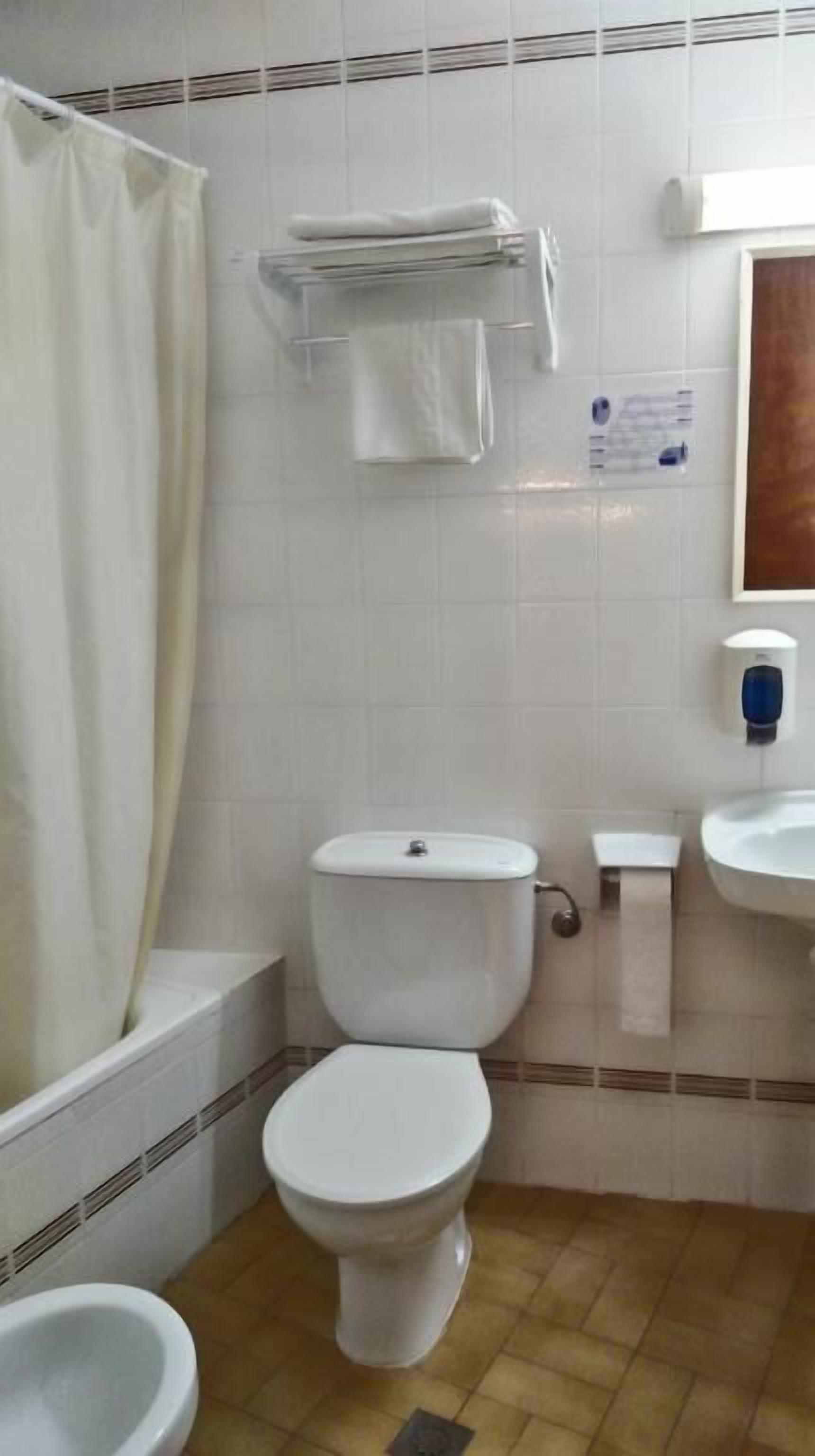 deep-soaking bathtub, rainfall showerhead, hair dryer, towels