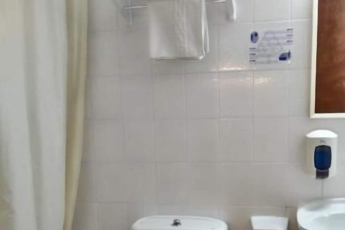 deep-soaking bathtub, rainfall showerhead, hair dryer, towels