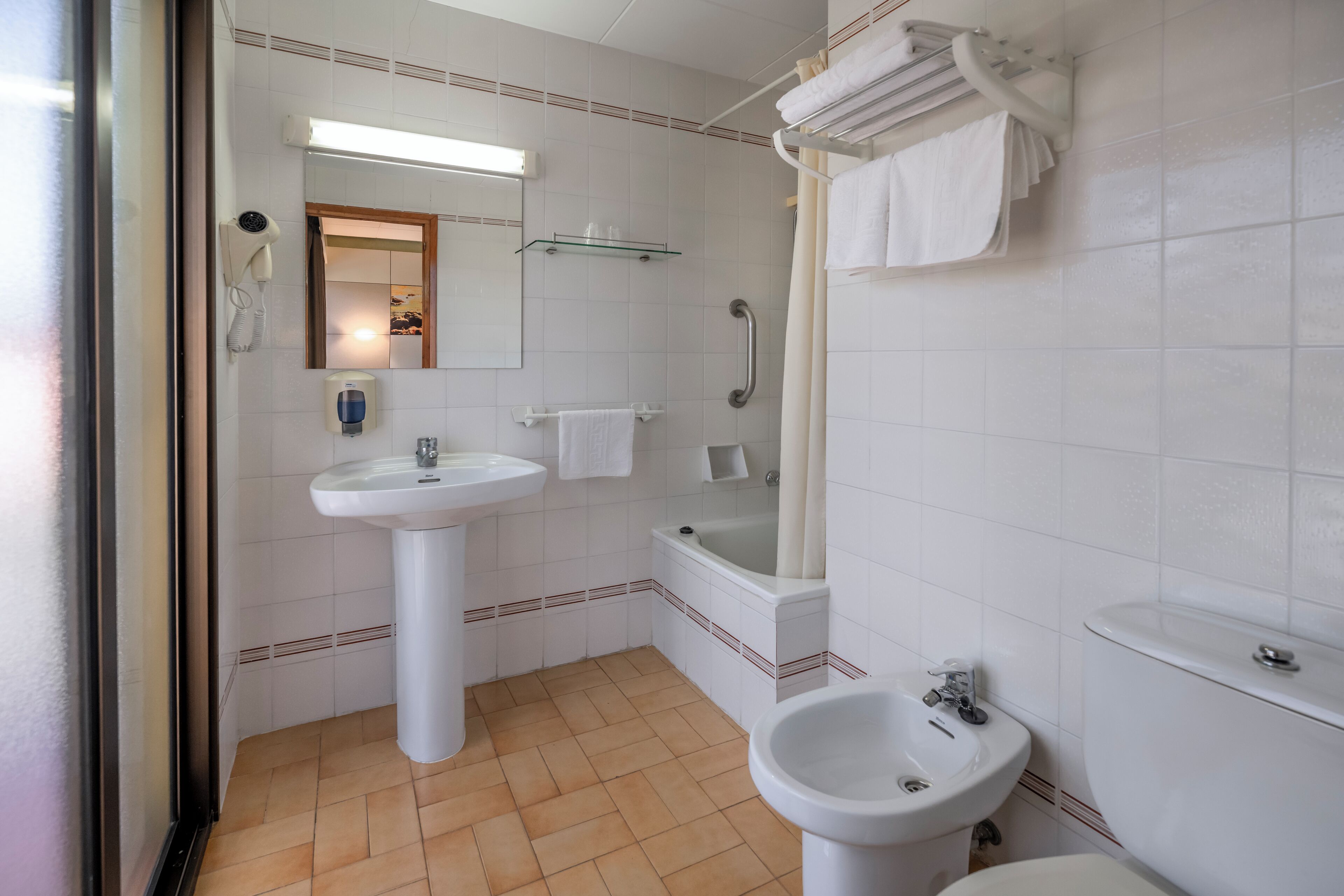 deep-soaking bathtub, rainfall showerhead, hair dryer, towels