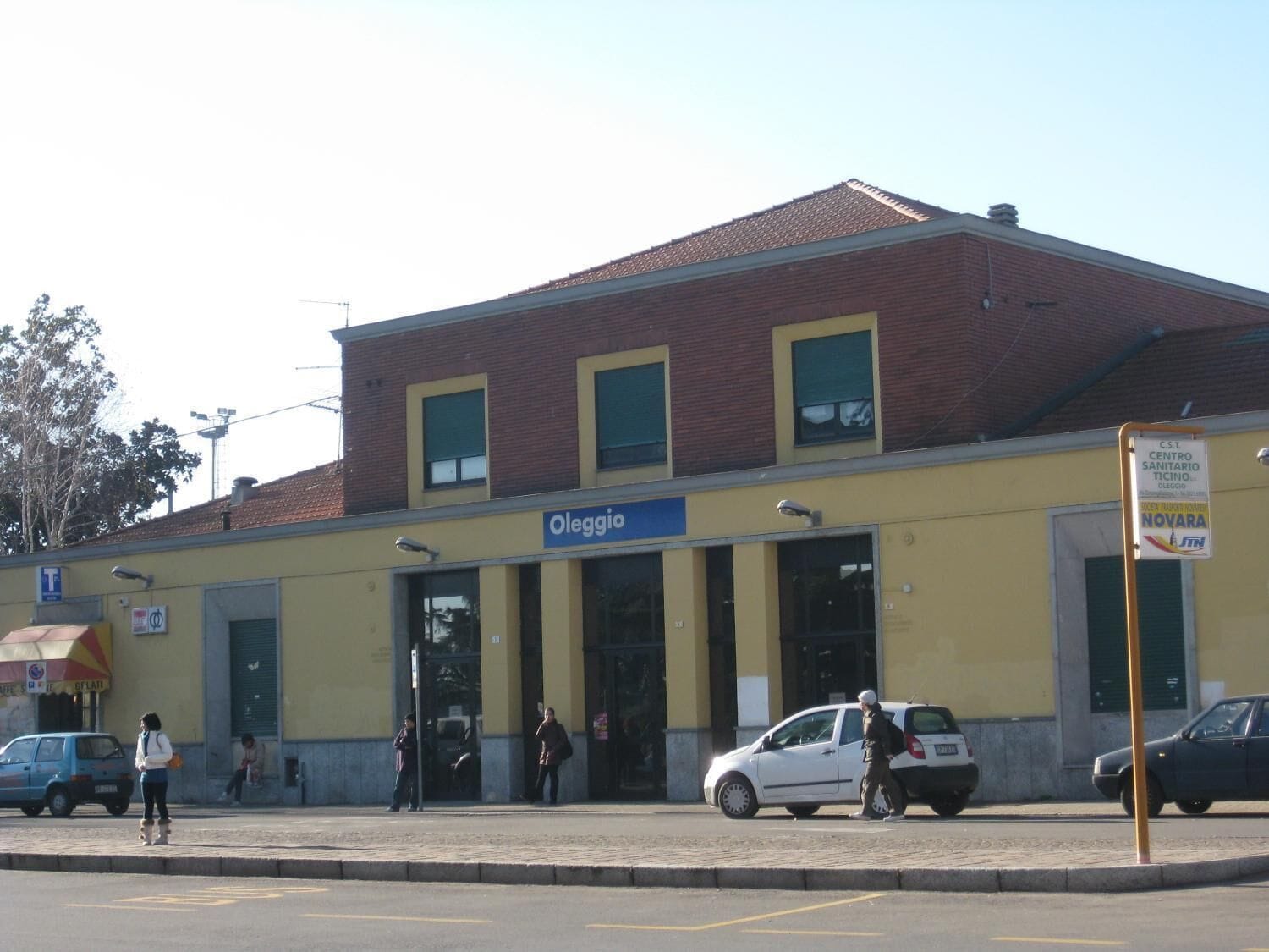 Un edificio con fachada amarilla y un letrero que dice 'Oleggio'.