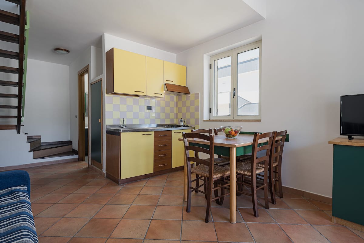 Apartment, 1 Bedroom (Sibari) | Living area | 21-inch TV with satellite channels