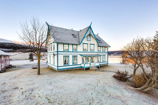 A large, two-story house with a steeply pitched roof and a balcony. - Sandtorgholmen Hotel, BW Signature Collection (Harstad)
