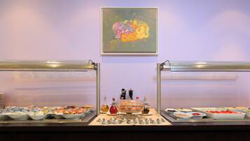 A buffet setup with various food items and condiments.