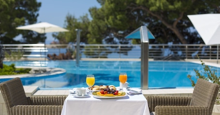 Indoor pool, seasonal outdoor pool, open 8 AM to 8 PM, pool umbrellas