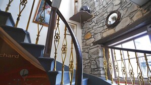 A staircase with ornate metal railings and stone walls. - Orchard Hotel (Falkirk)