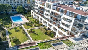 A multi-story hotel with balconies, a swimming pool, and a well-maintained garden. - Nemea Appart Hotel Le Lido Cagnes sur Mer (Cagnes-sur-Mer)