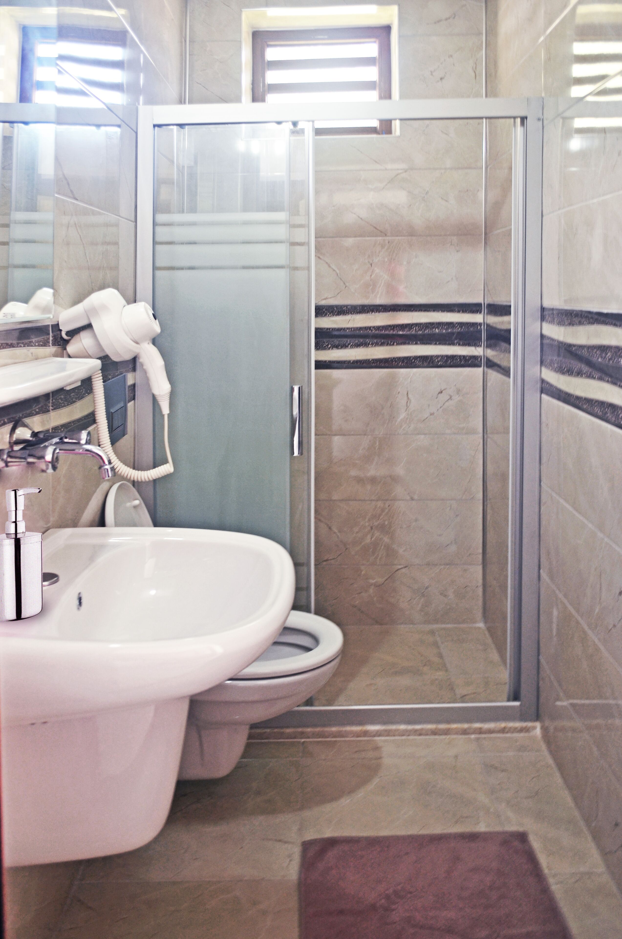 shower, hair dryer, slippers, towels