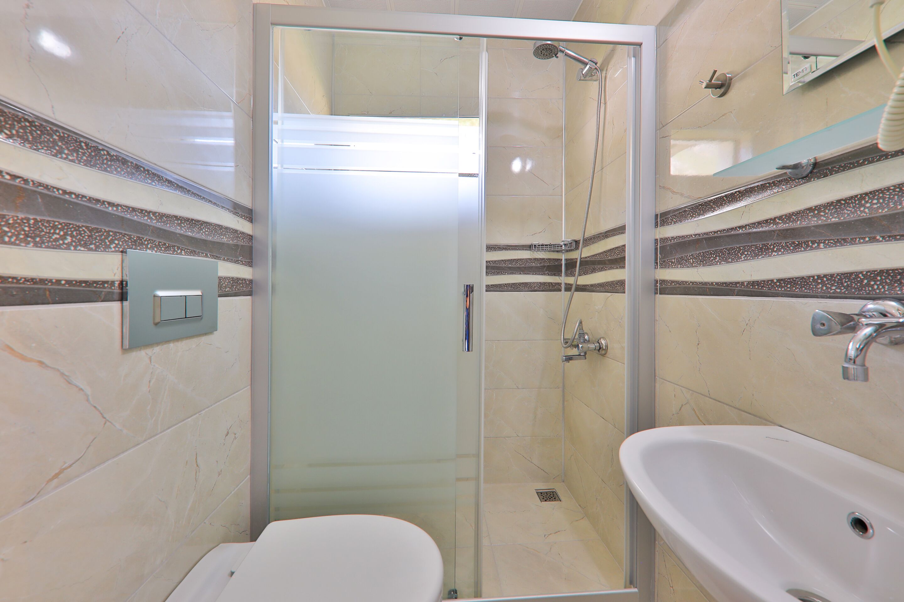 shower, hair dryer, slippers, towels