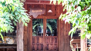 Una puerta de recepción de madera con un cartel en la parte superior.