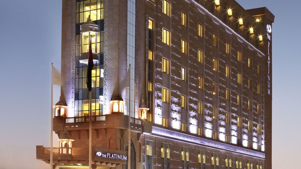 A multi-story hotel with a prominent entrance and illuminated windows.