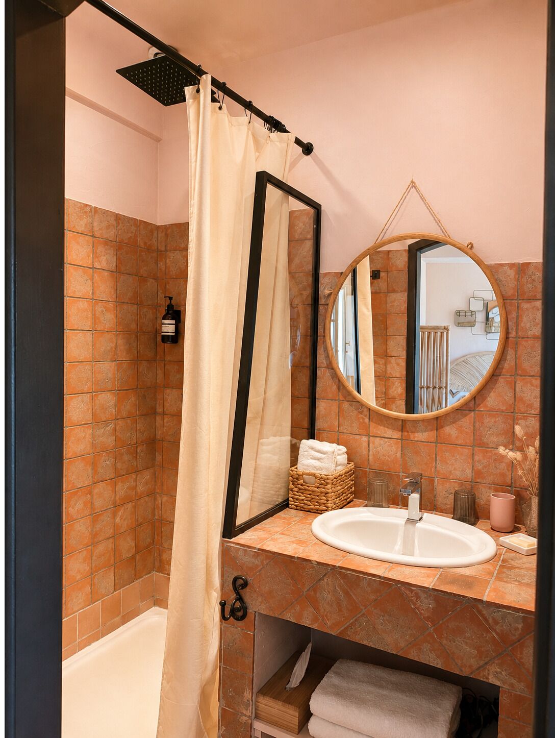 A bathroom with a bathtub, a sink, a mirror, and a shower curtain.