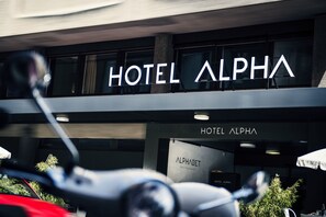 The exterior of Hotel Alpha with a sign indicating it houses an Alphabet Restaurant. - Hotel Alpha (Fribourg)