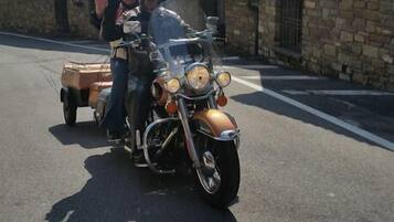 A vintage motorcycle with a sidecar parked on a street.