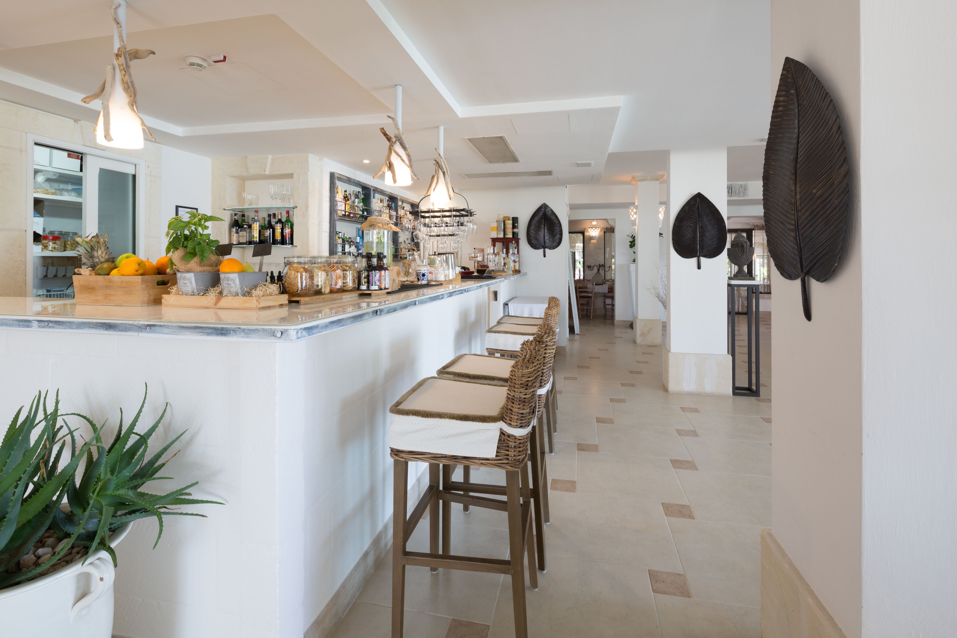 A modern kitchen with a central island, bar area, and seating.